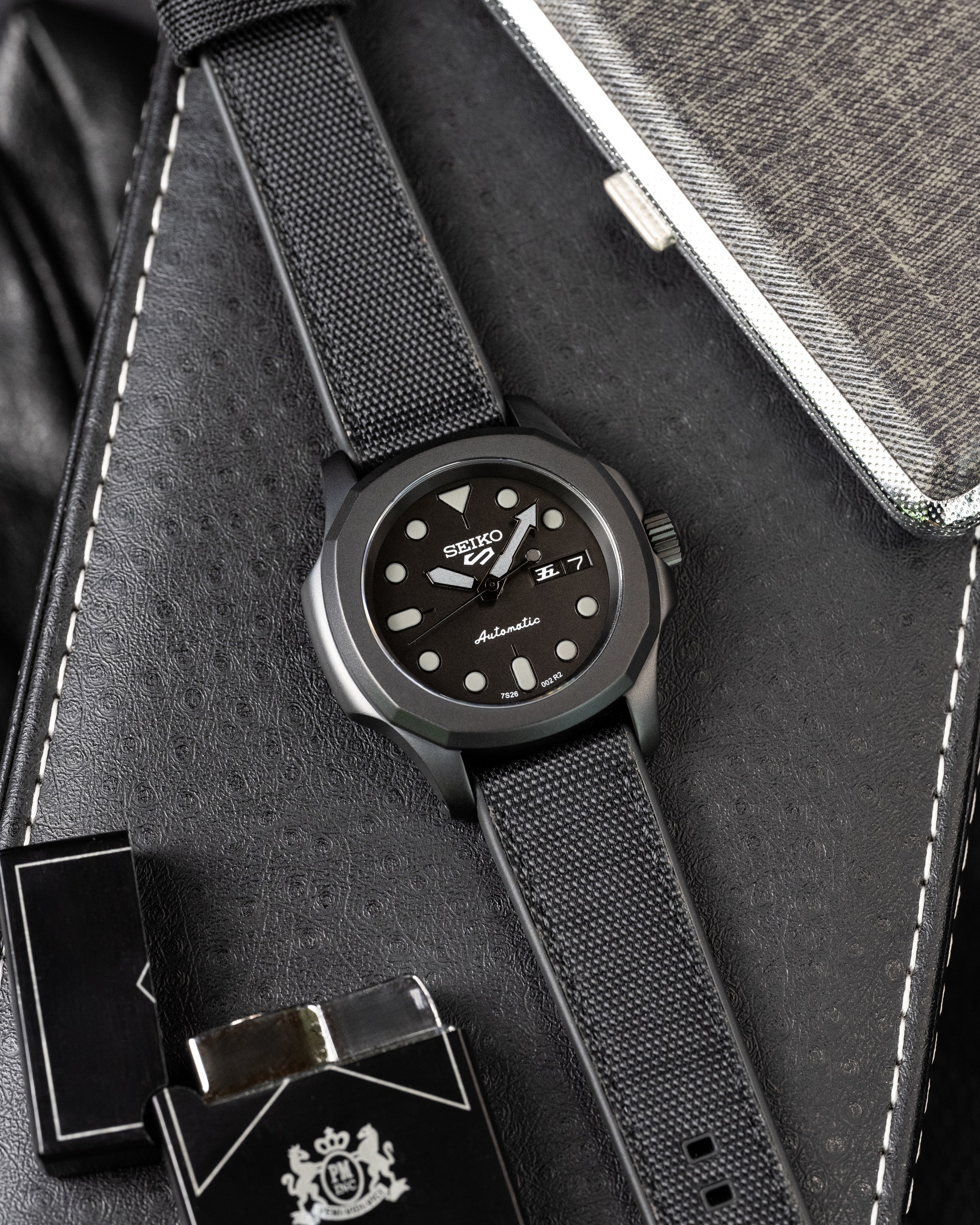 Custom Seiko 5 Mod Blackout – Watch With Matte Black Stealth Nautilus Case Black Dial With Bold Lume Markers Arrow Handset And Canvas Strap
