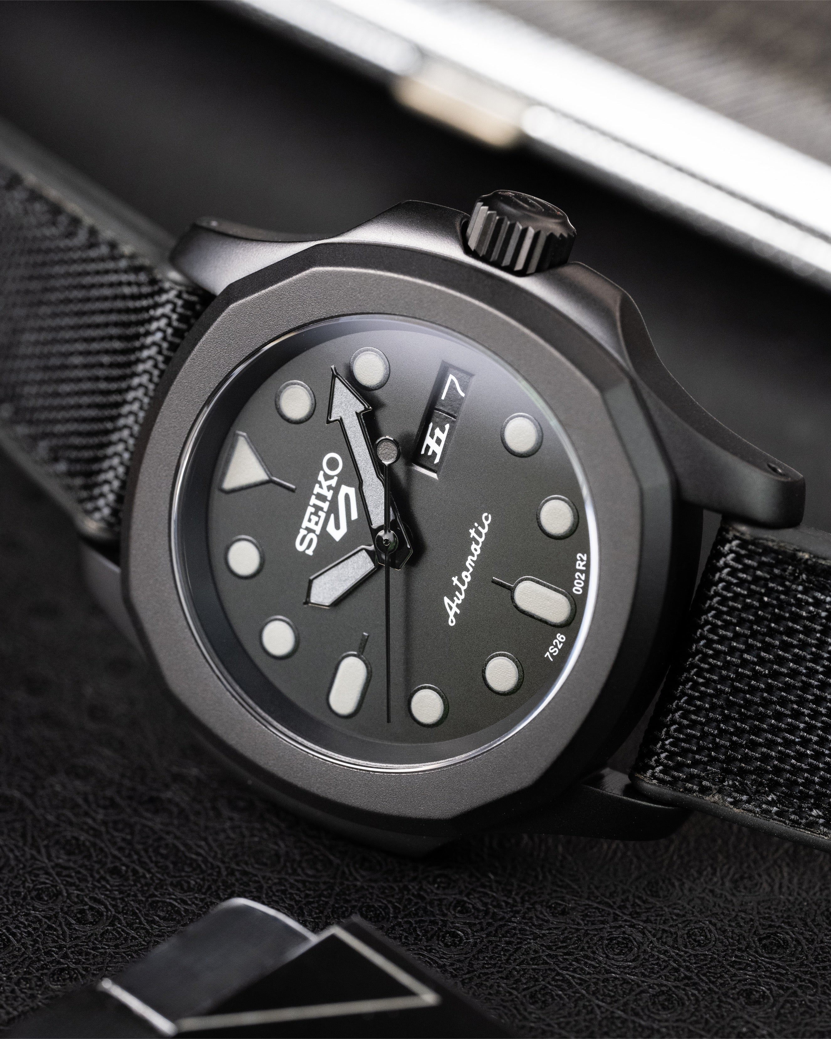 Custom Seiko 5 Mod Blackout – Watch With Matte Black Stealth Nautilus Case Black Dial With Bold Lume Markers Arrow Handset And Canvas Strap