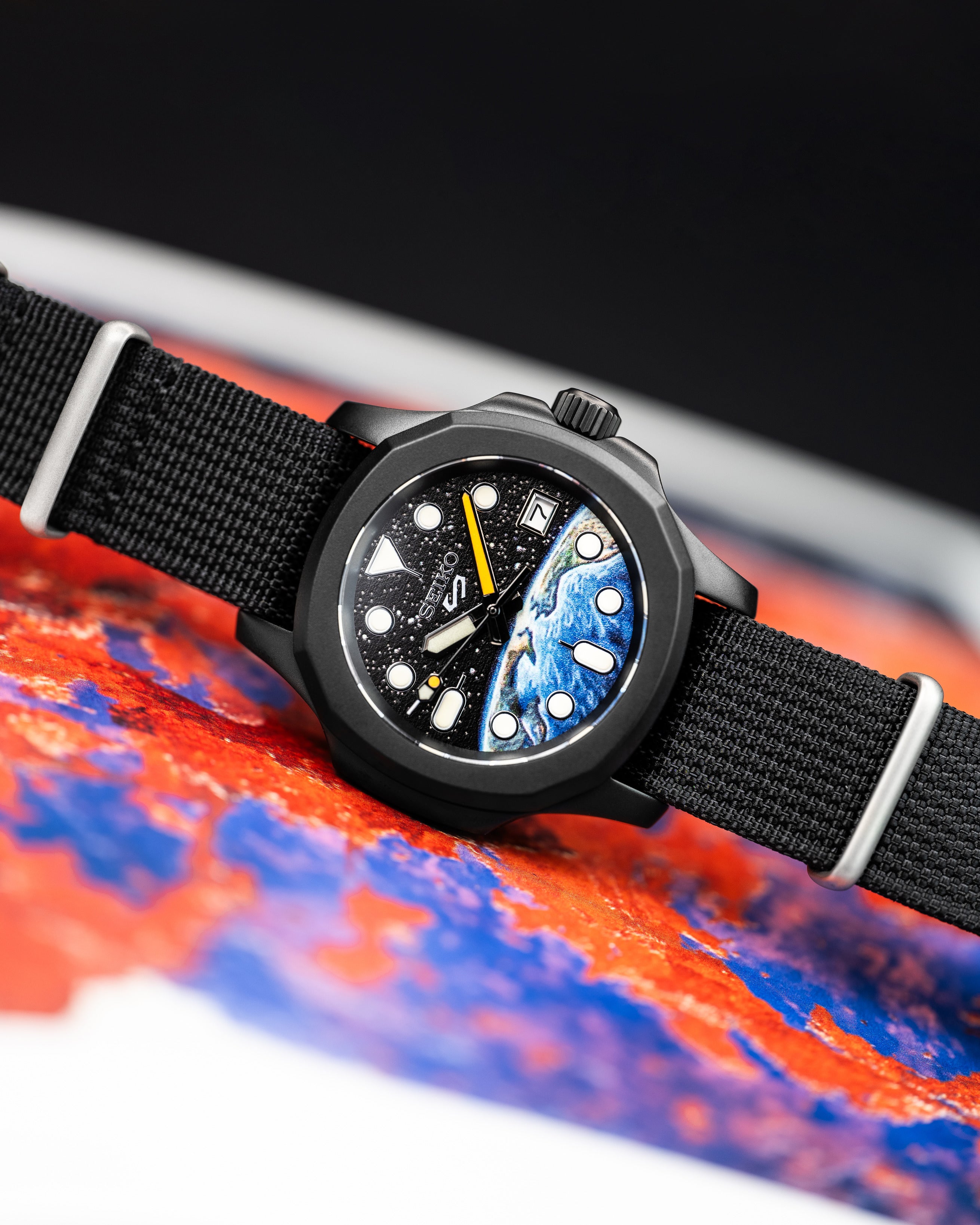 Custom Seiko 5 Mod Watch – Space Inspired Dial With Earth Artwork Matte Black Nautilus Case Orange-Accented Hands And Black Nato Strap