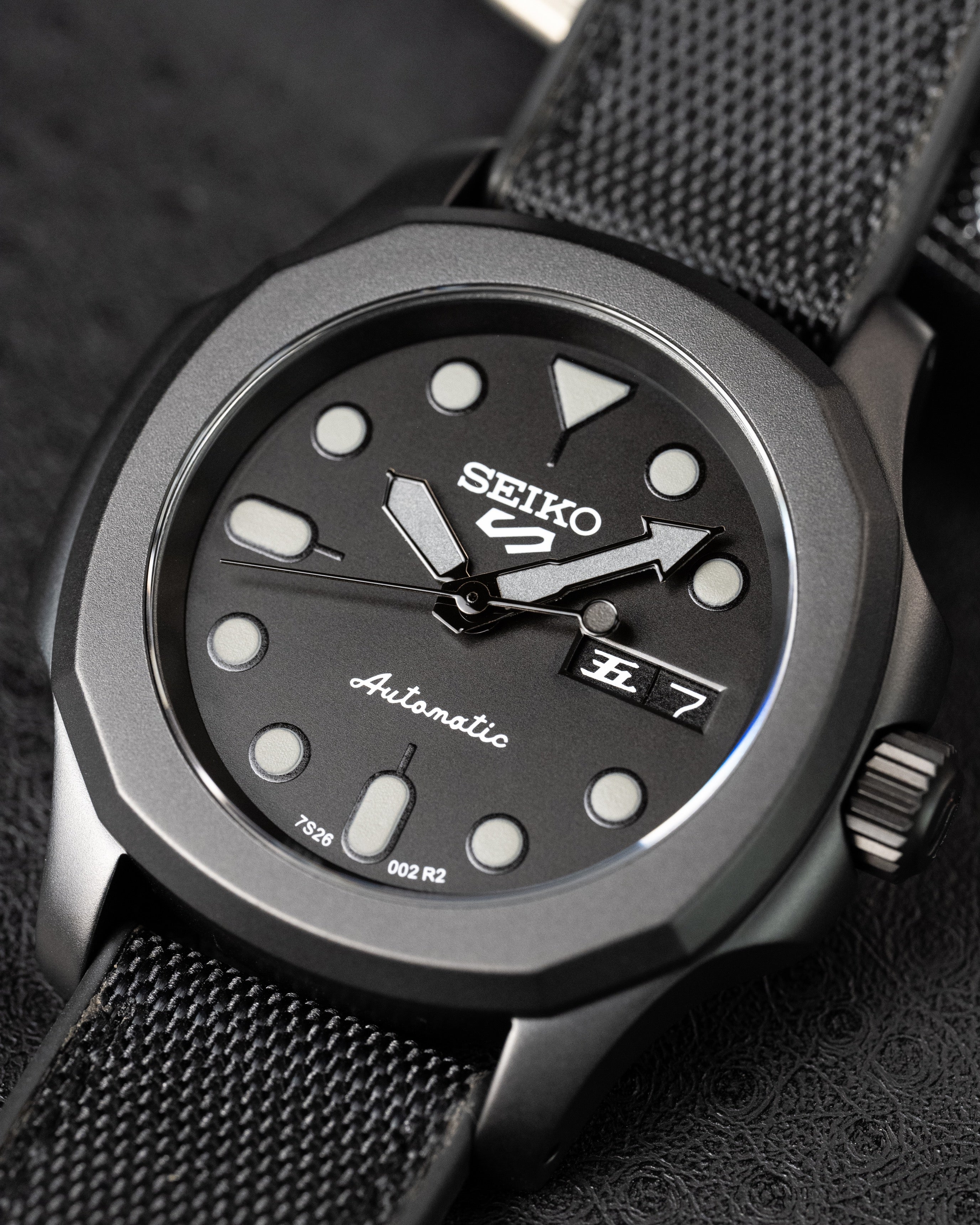 Custom Seiko 5 Mod Blackout – Watch With Matte Black Stealth Nautilus Case Black Dial With Bold Lume Markers Arrow Handset And Canvas Strap